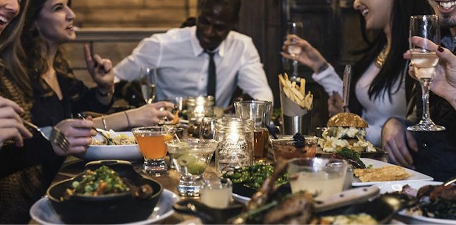 a group of people sitting at a table with wine glasses