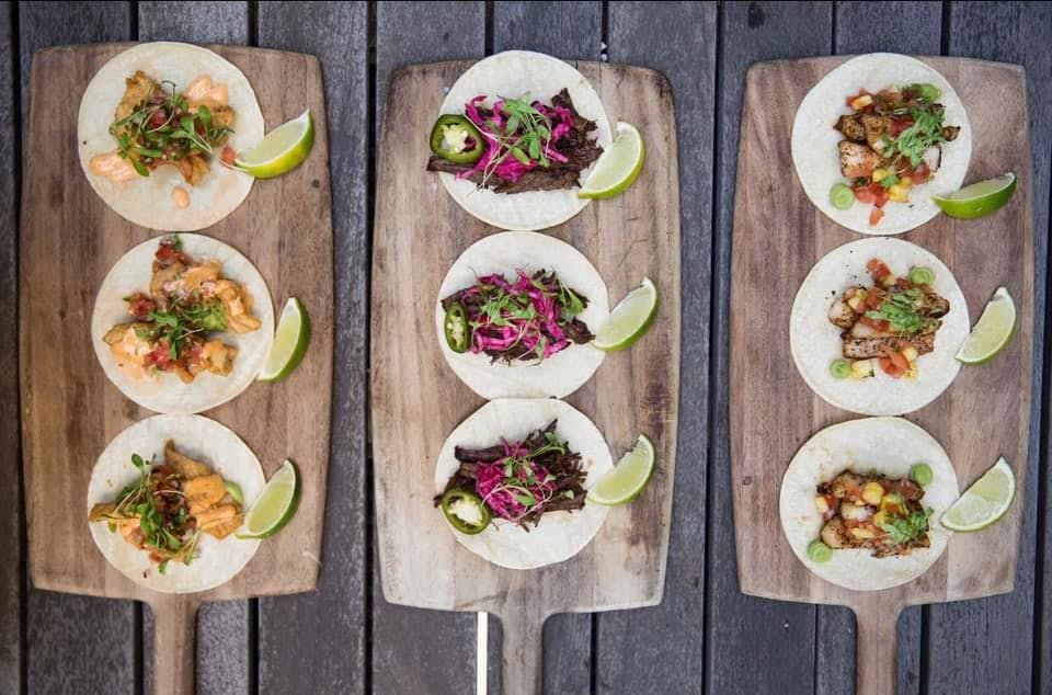 a bunch of different types of food on a wooden table