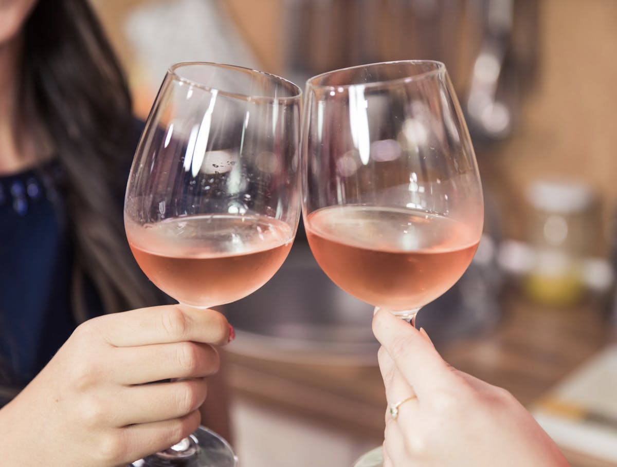 a hand holding a glass of wine