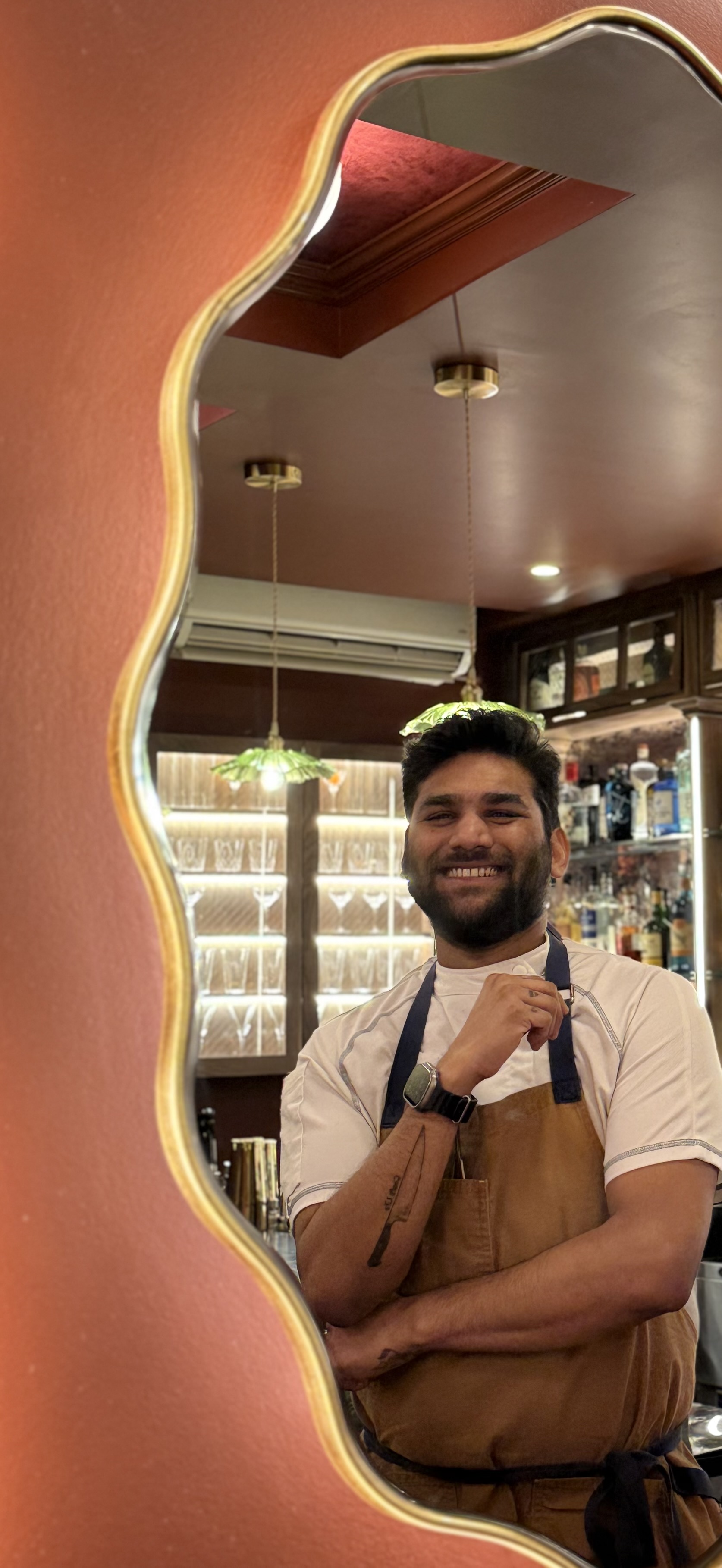 a man in an apron smiling