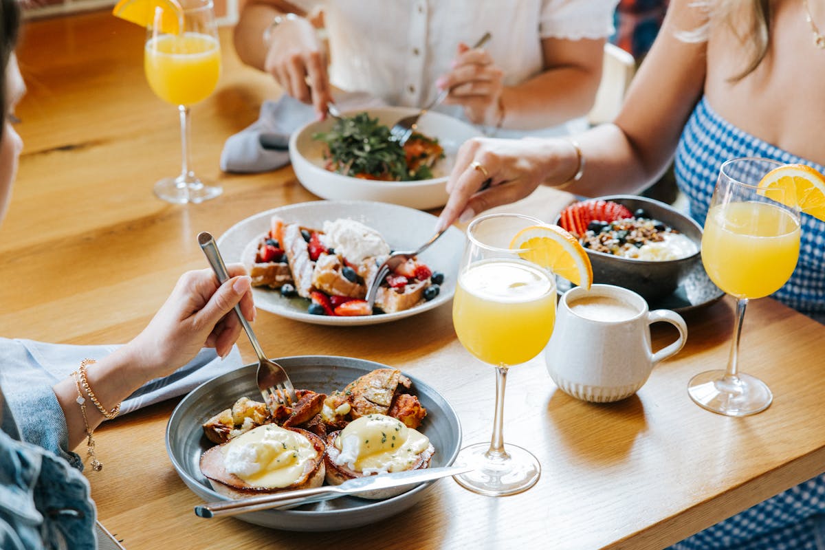 a woman sitting at a table with a plate of food