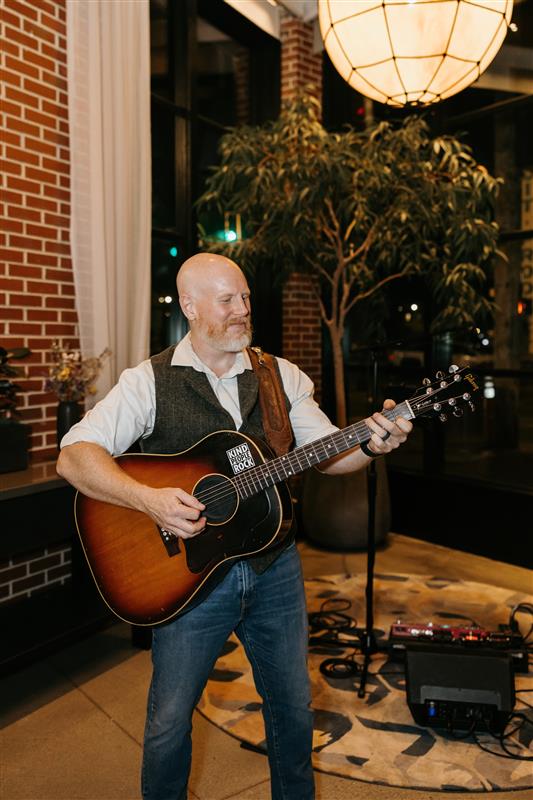 a man playing a guitar