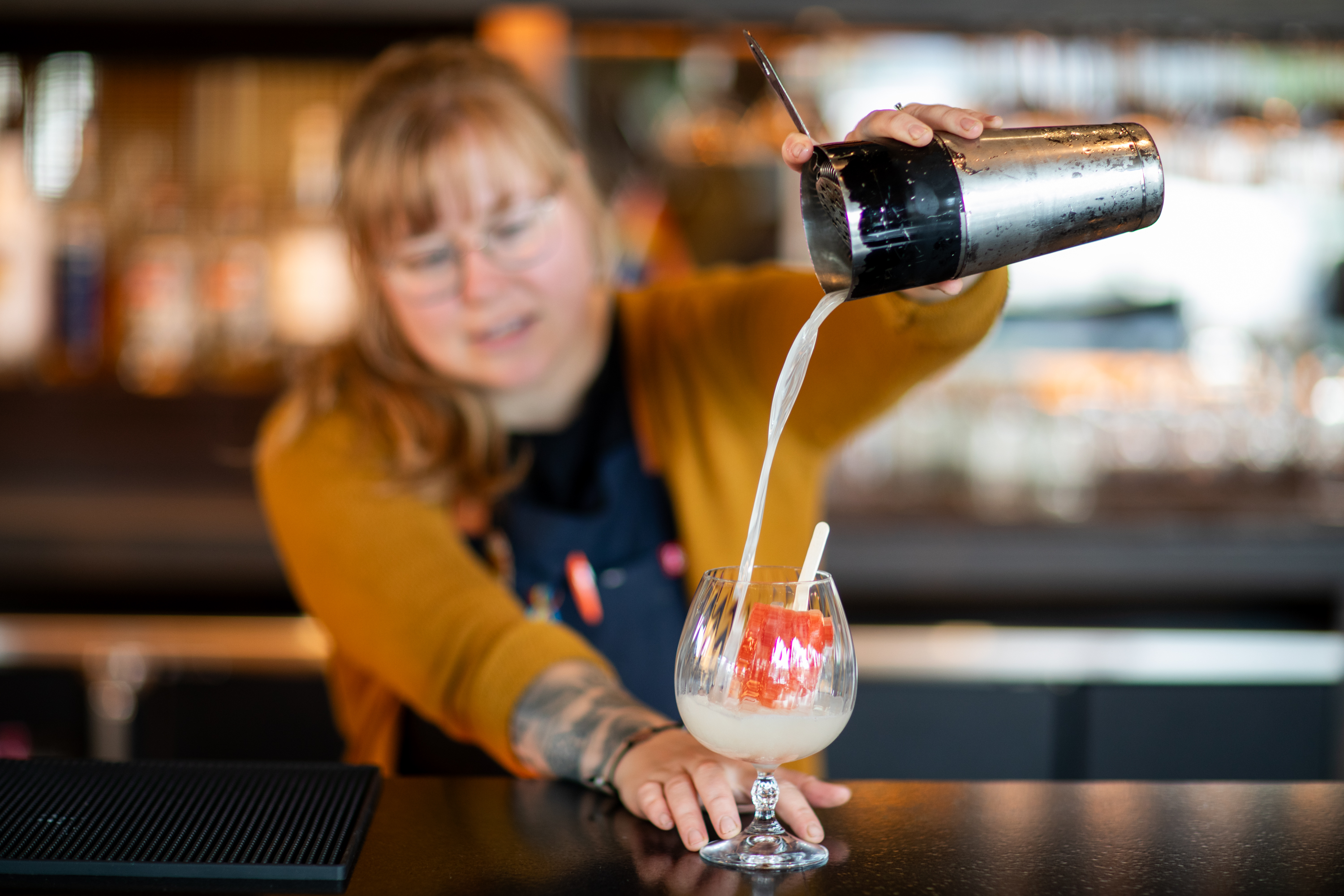 a cup of coffee sitting on top of a wooden cutting board