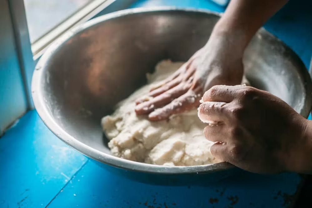 a person cooking food in a bowl