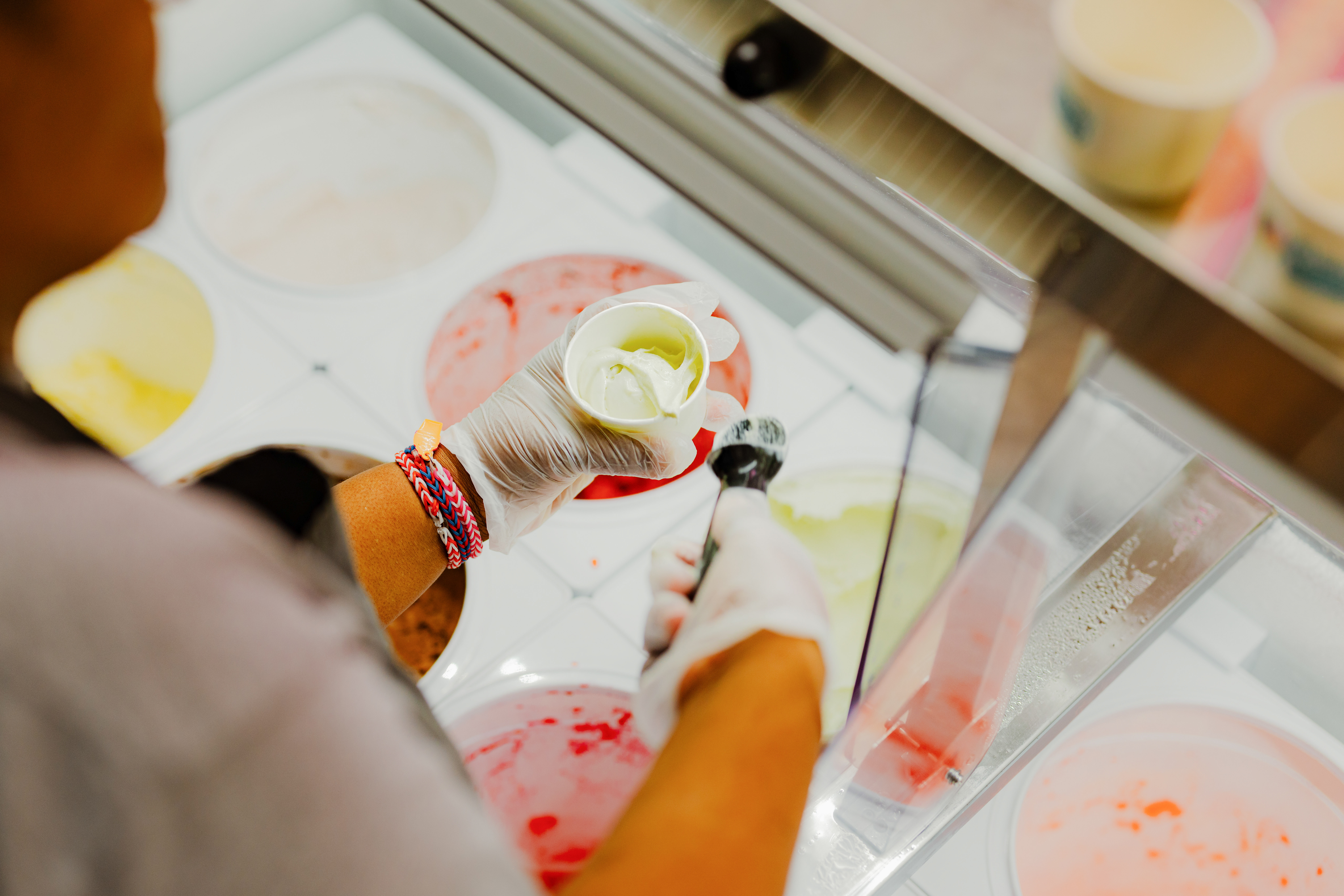 a person holding a scoop of ice cream