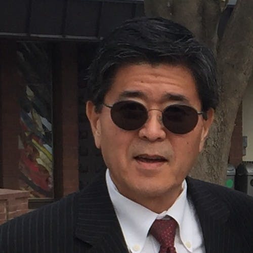 Xiaolong Zheng wearing a suit and tie