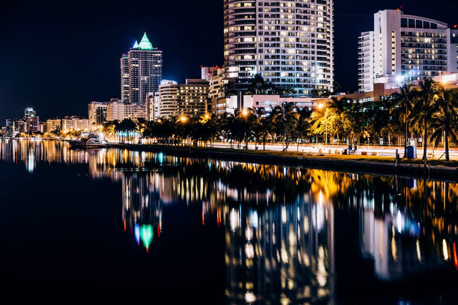 a body of water with a city in the background