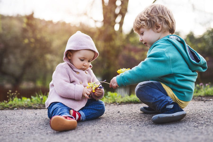 a small child sitting on the ground