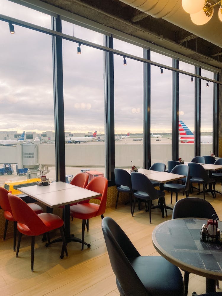 a view onto airport runway through restaurant windows