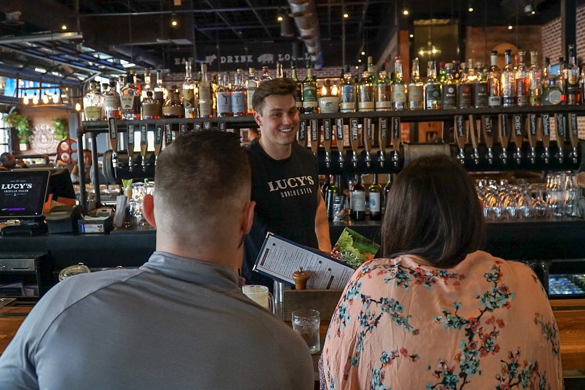 a group of people a the bar stand