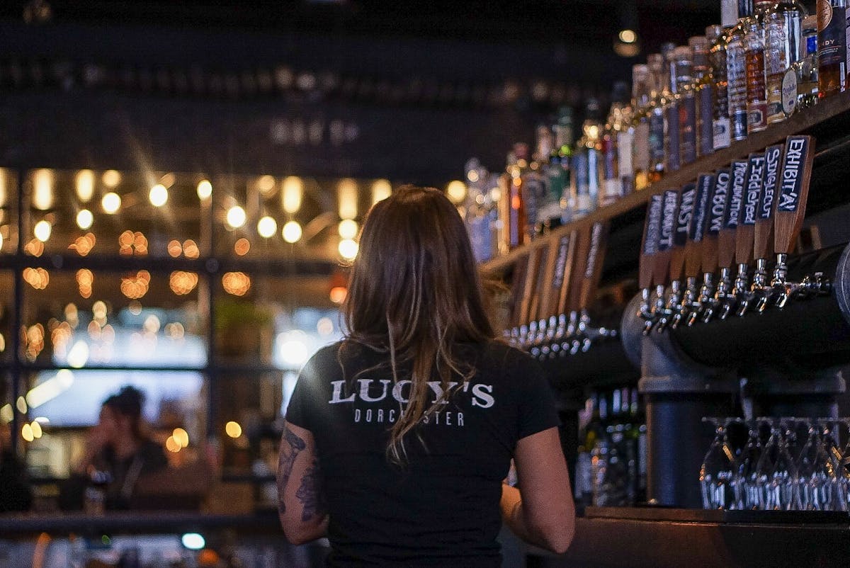 a staff member at the bar stand