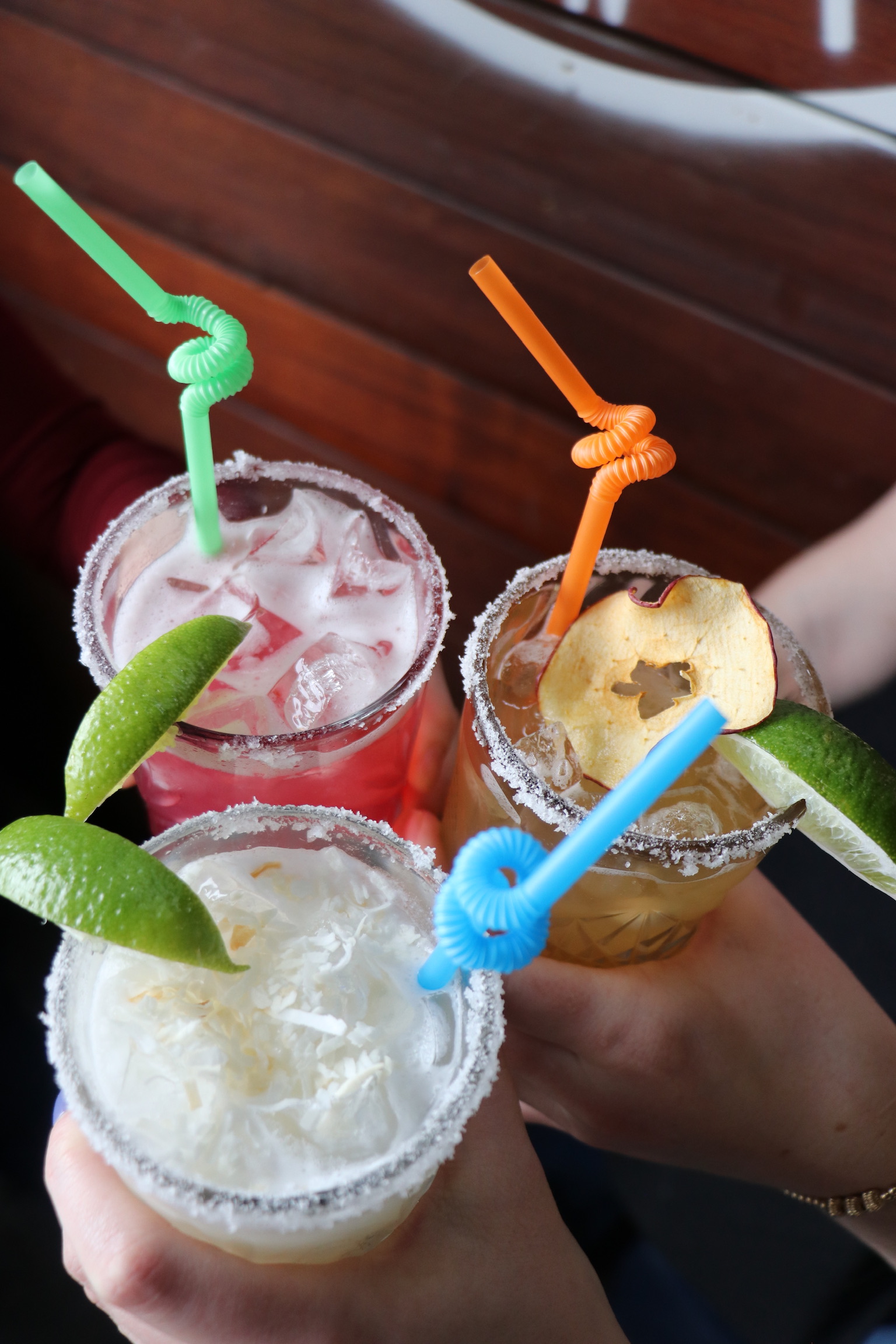 a group of drinks with straws