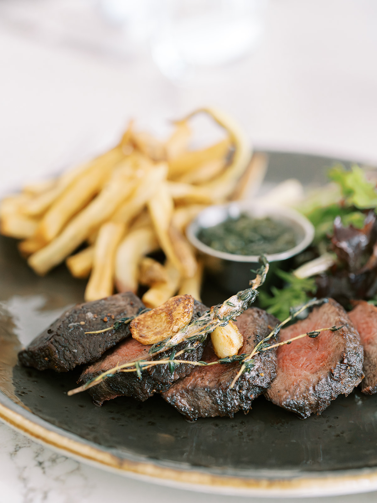 a plate of food with a side of french fries and a sauce