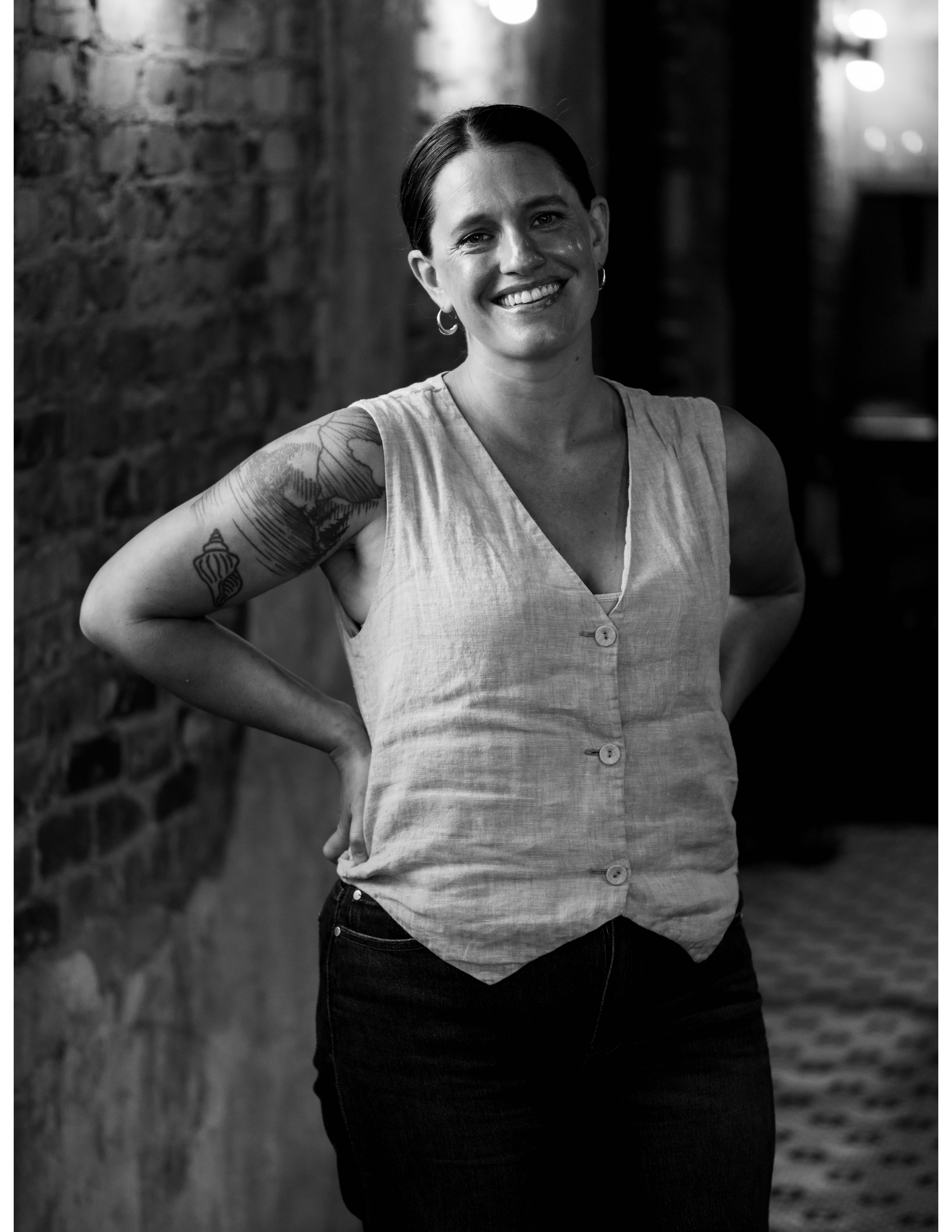 a woman smiling with her hand on her hip
