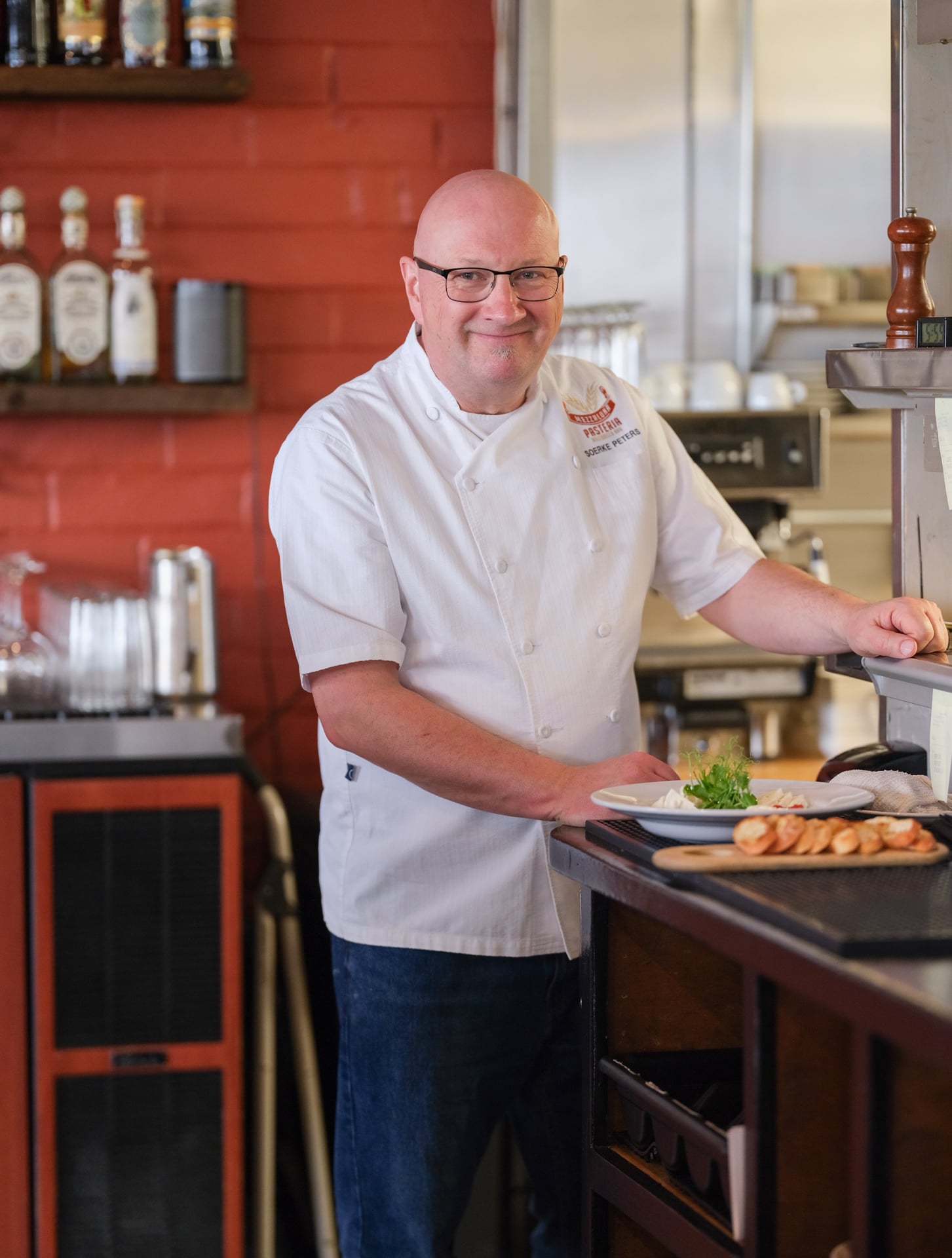 a man standing in a kitchen preparing food