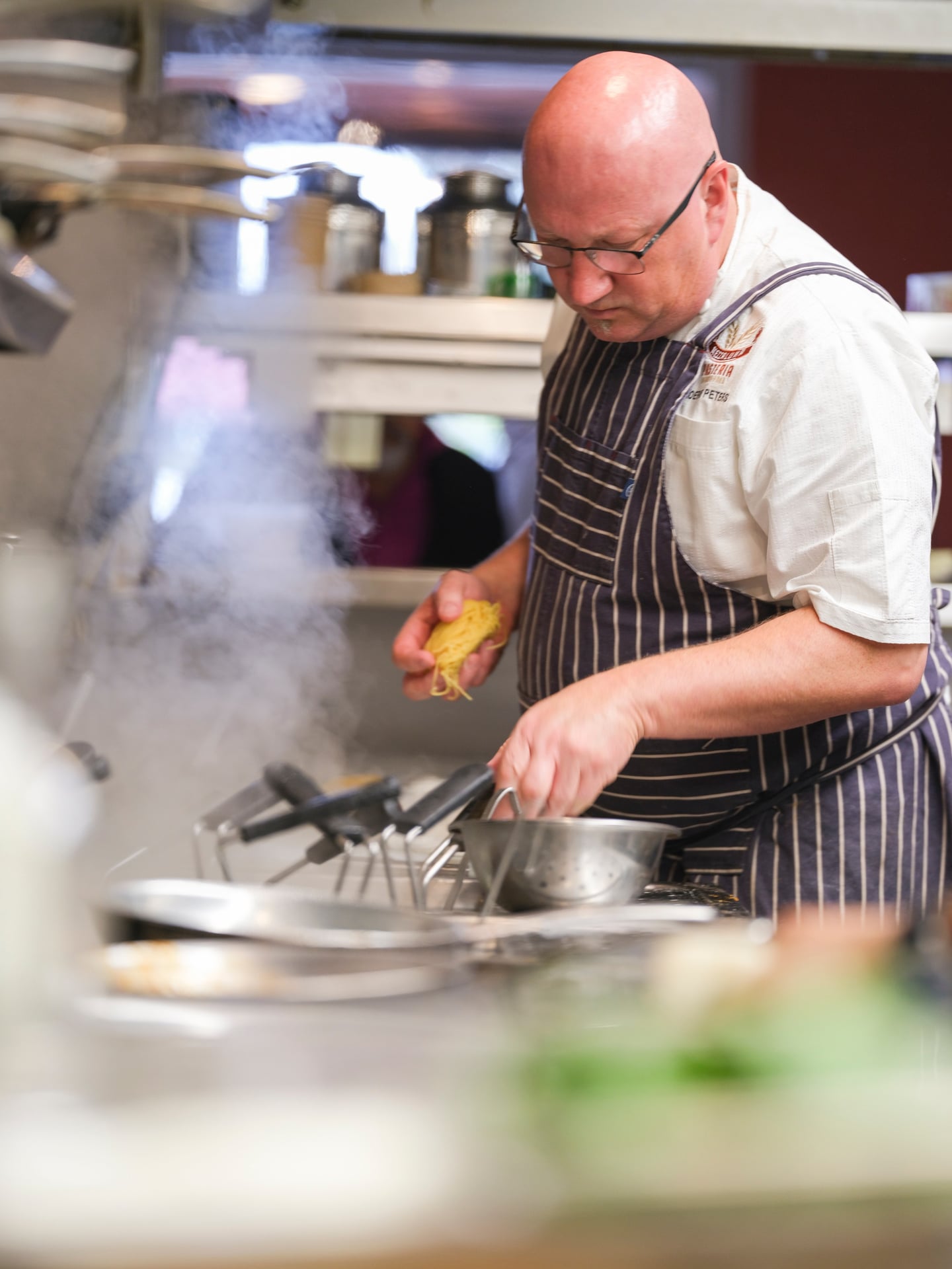 a man cooking in a kitchen preparing food