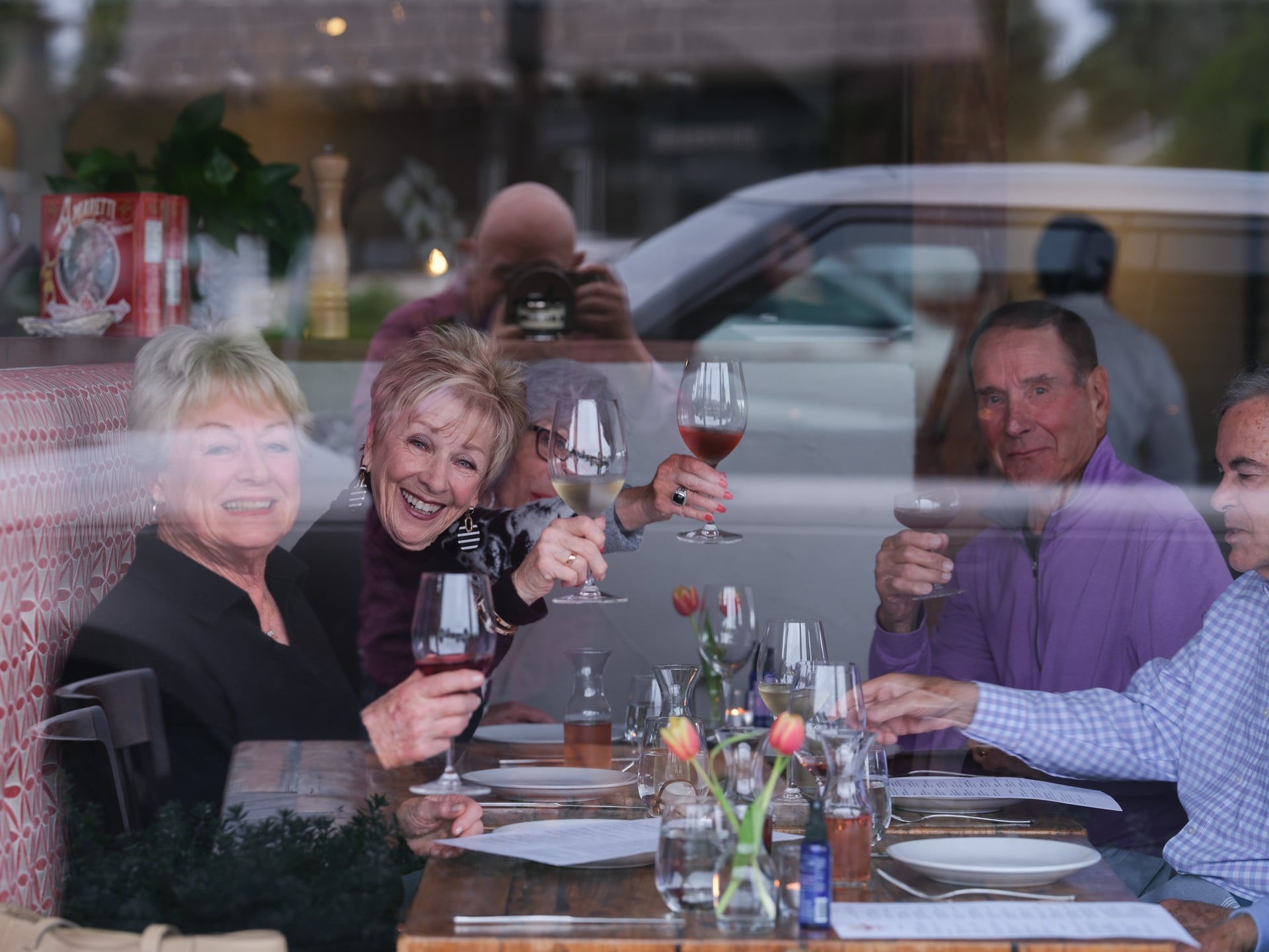 a group of people sitting at a table with wine glasses