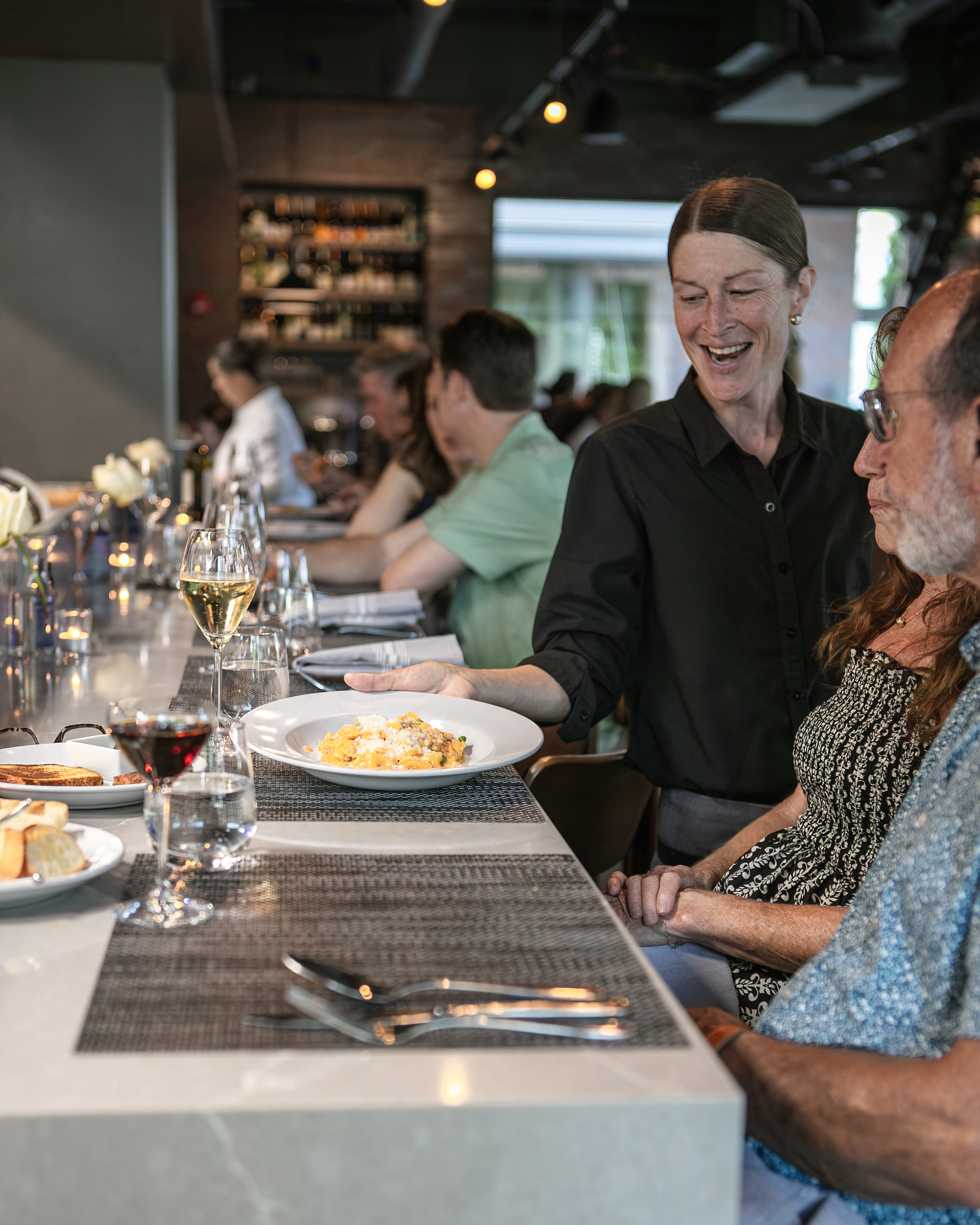 a group of people sitting at a table in a restaurant