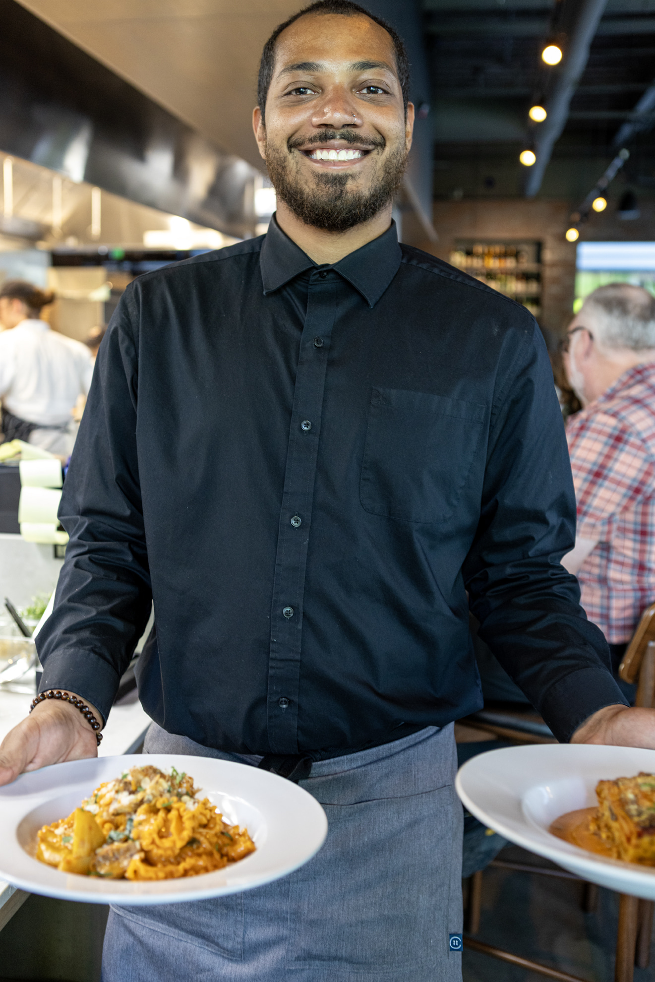 a man sitting at a table with a plate of food