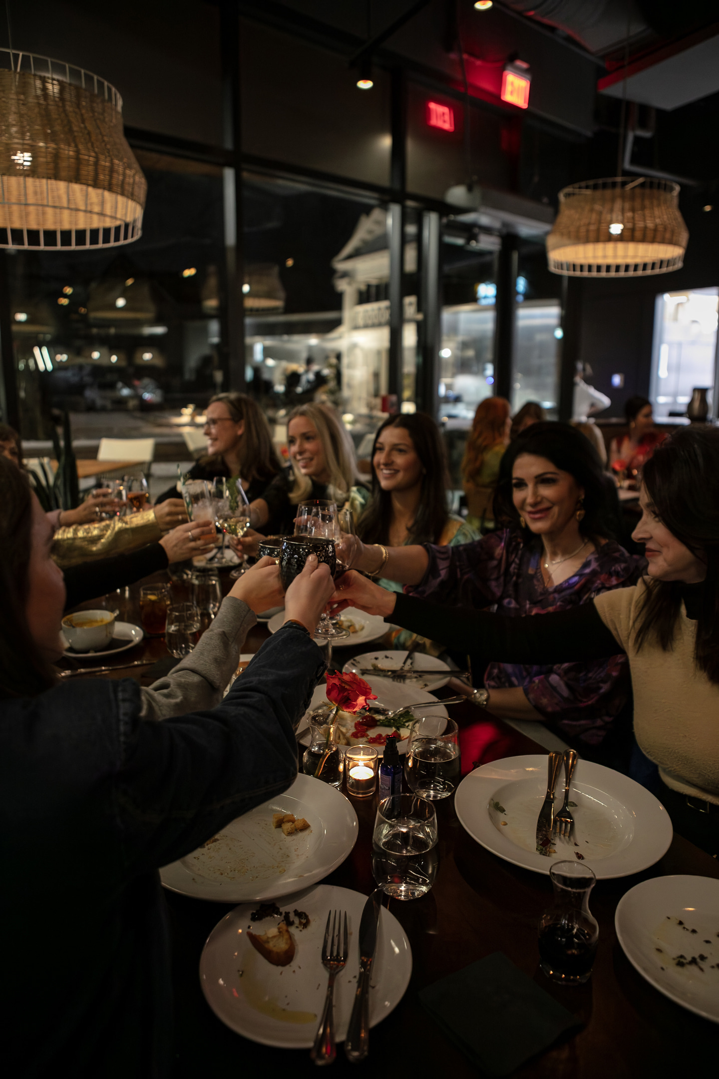 a group of people sitting at a table eating pizza