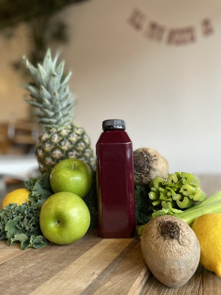 a green apple on top of a wooden table