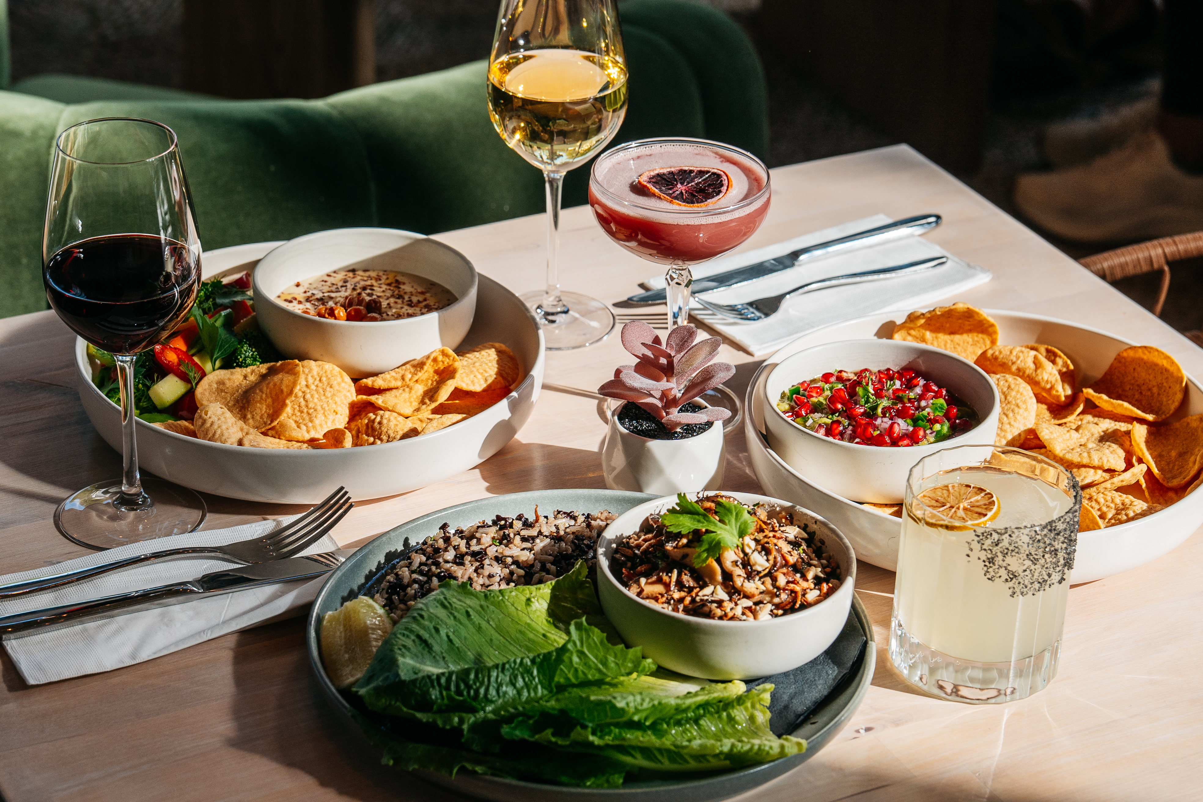 a table scape with assorted food and drinks
