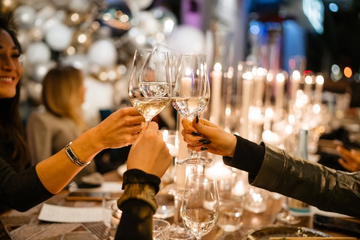 a group of people sitting at a table with wine glasses