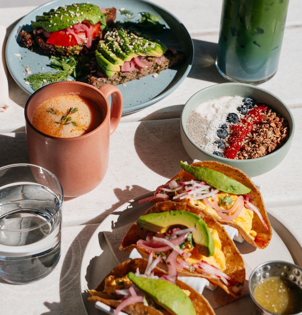 a table with plates of food and drinks