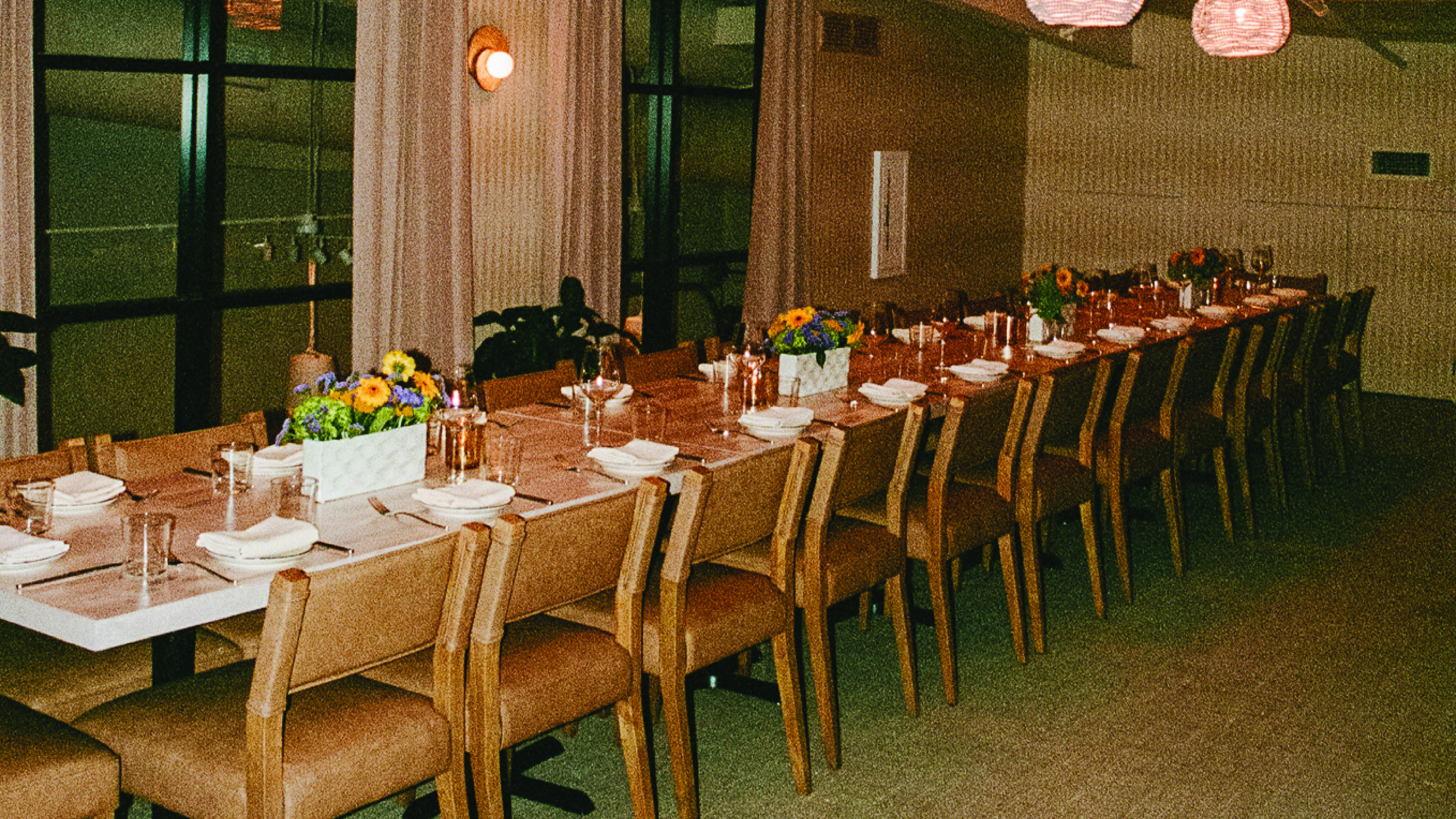 a group of people sitting at a table with wine glasses