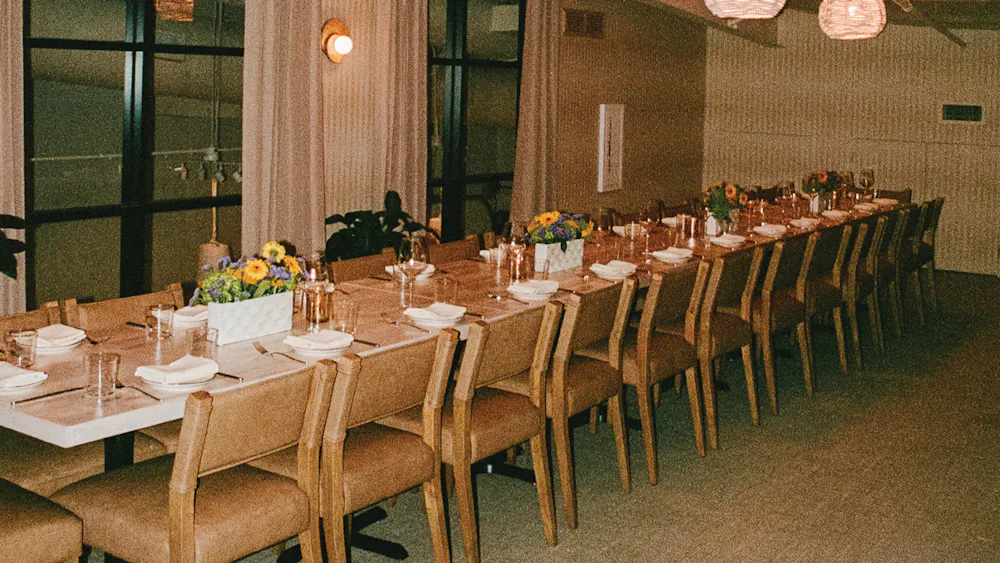a group of people sitting at a table with wine glasses
