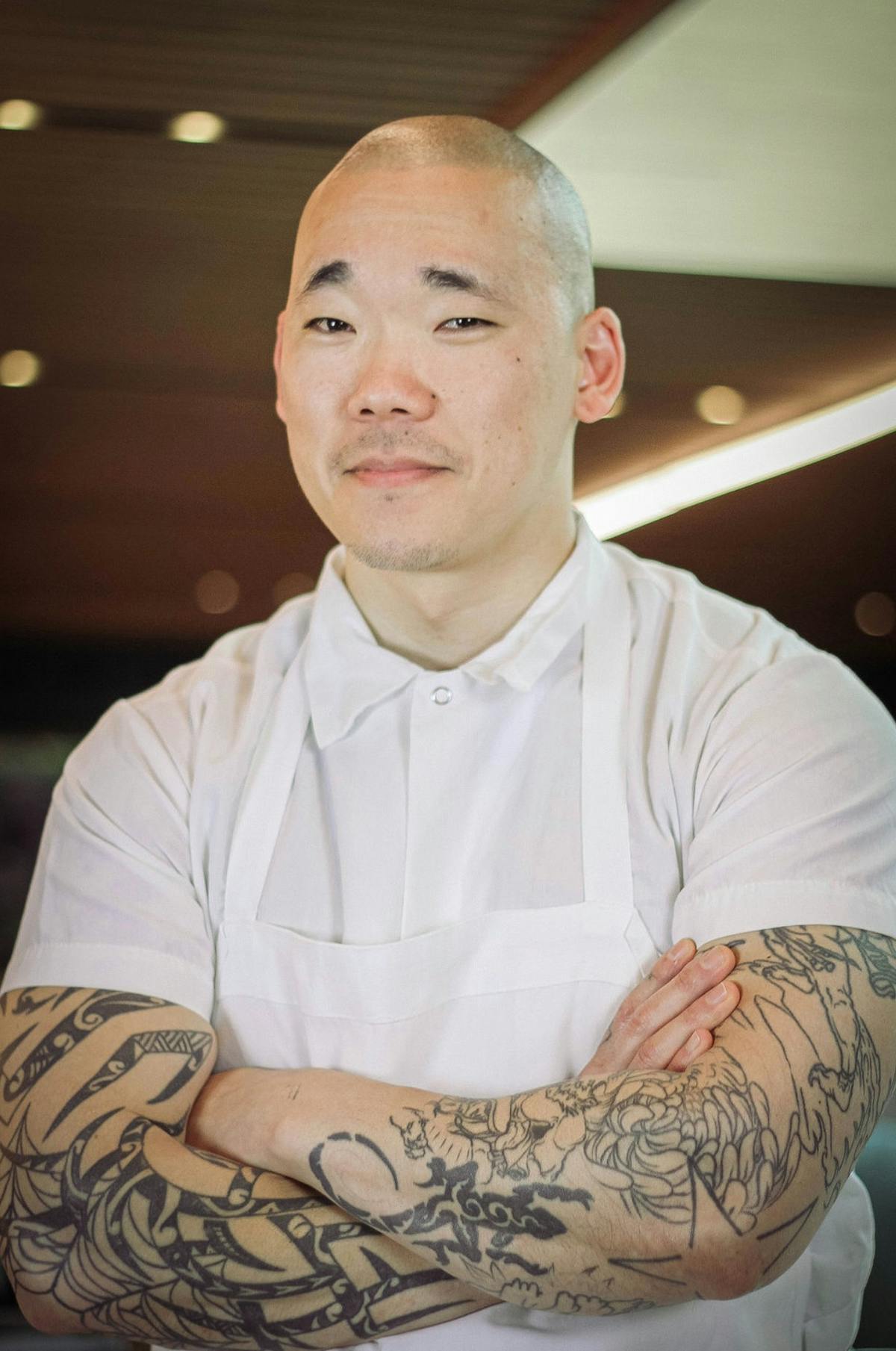 a man sitting on a tattoo on his arm