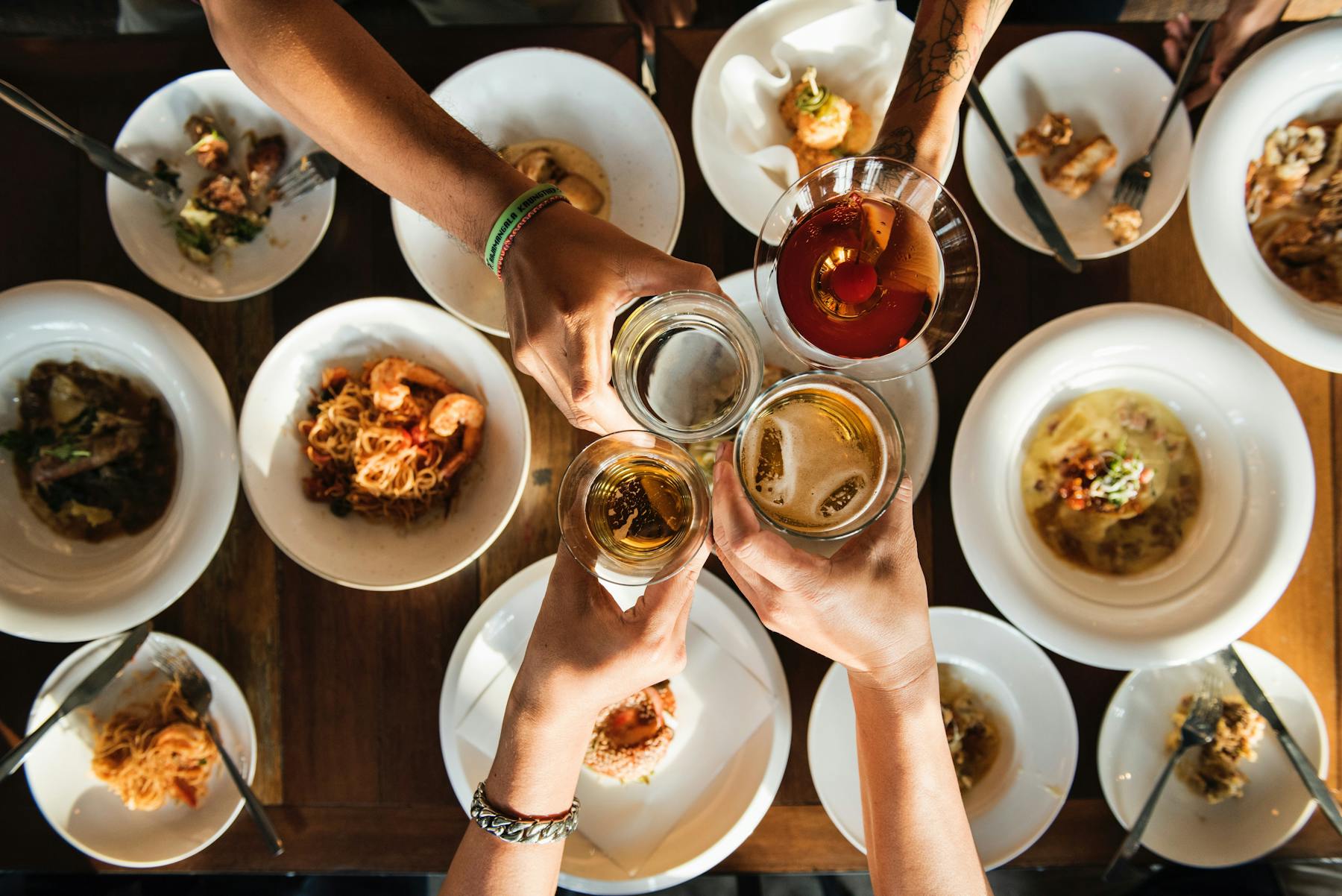 a group of people sitting at a table with a plate of food