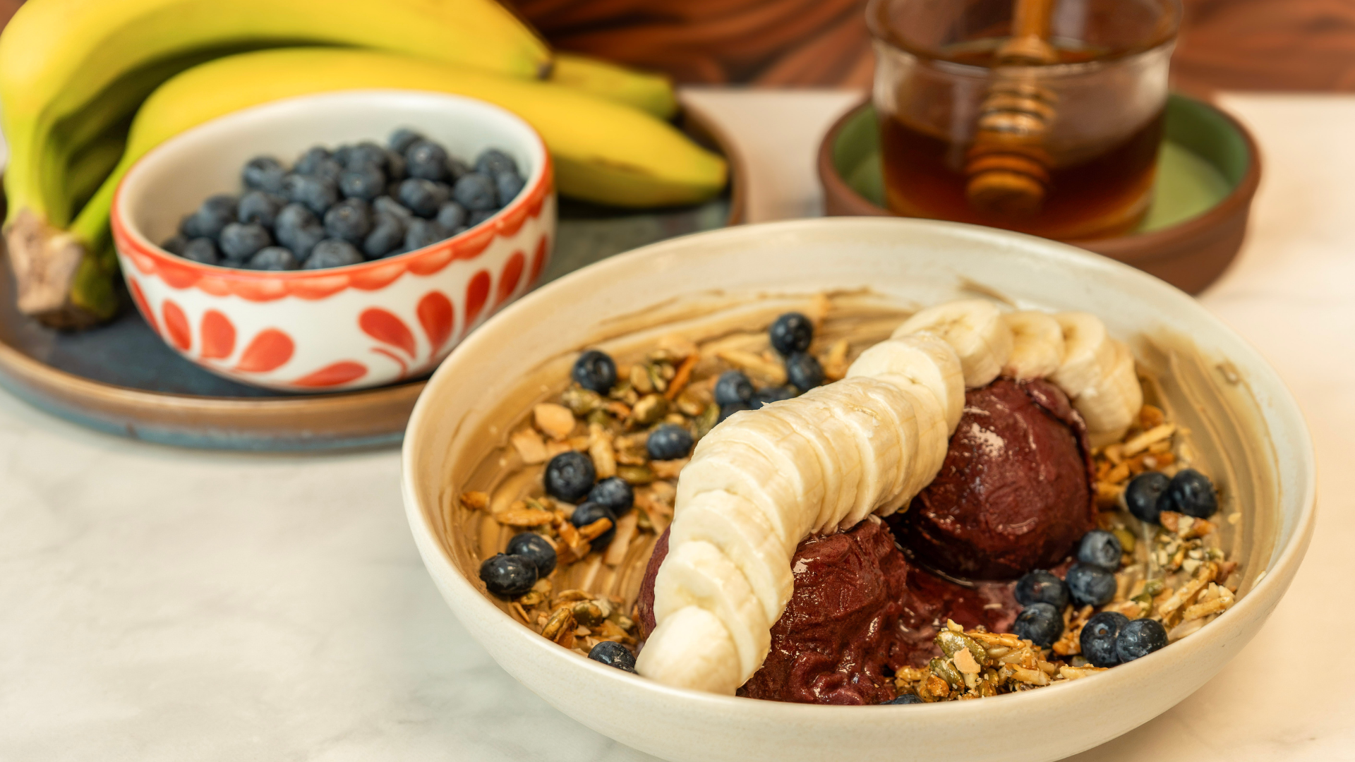 a bowl of food with bananas and blueberries