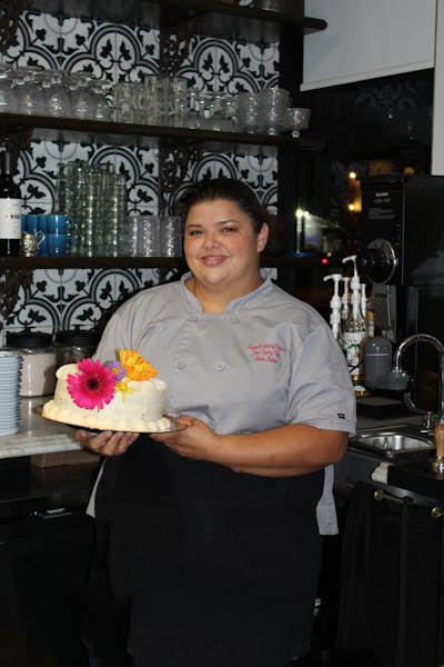 a person holding a birthday cake