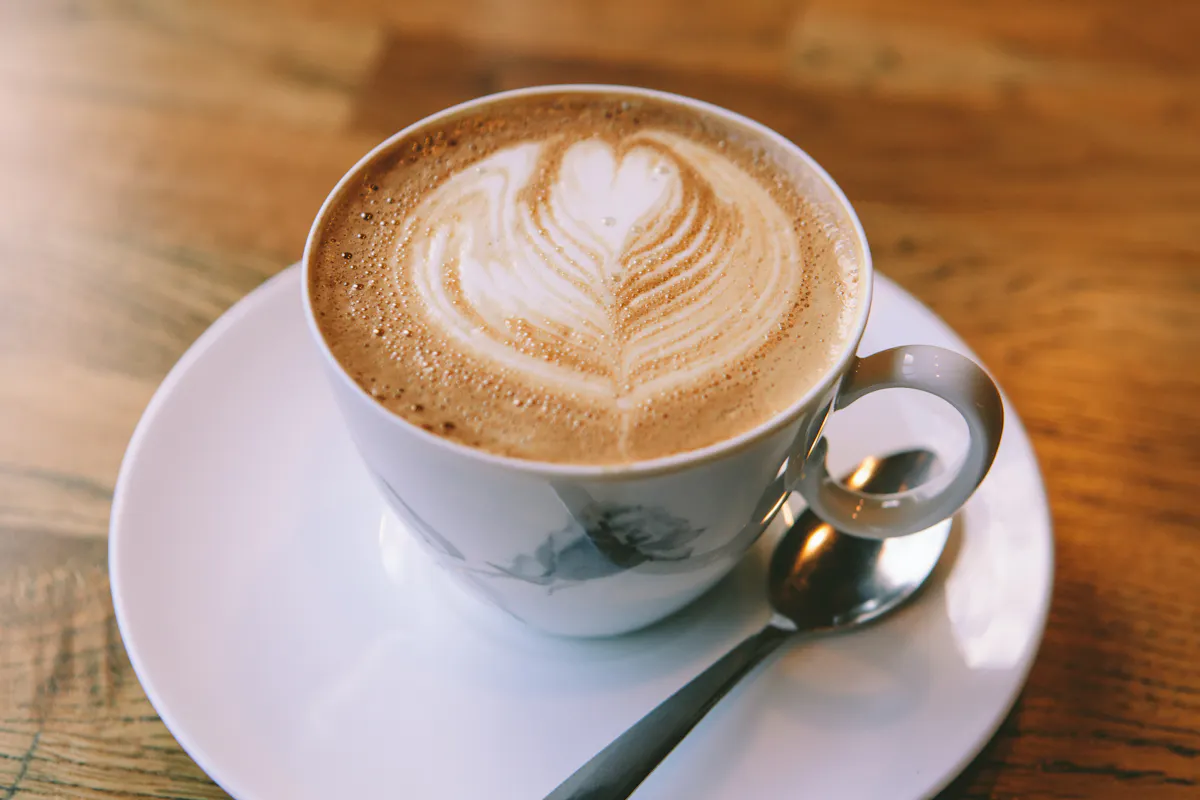 A latte on a white saucer at the restaurant