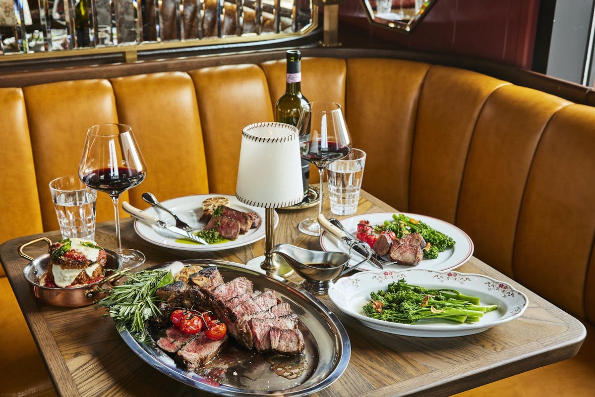 a plate full of food sitting on top of a wooden table