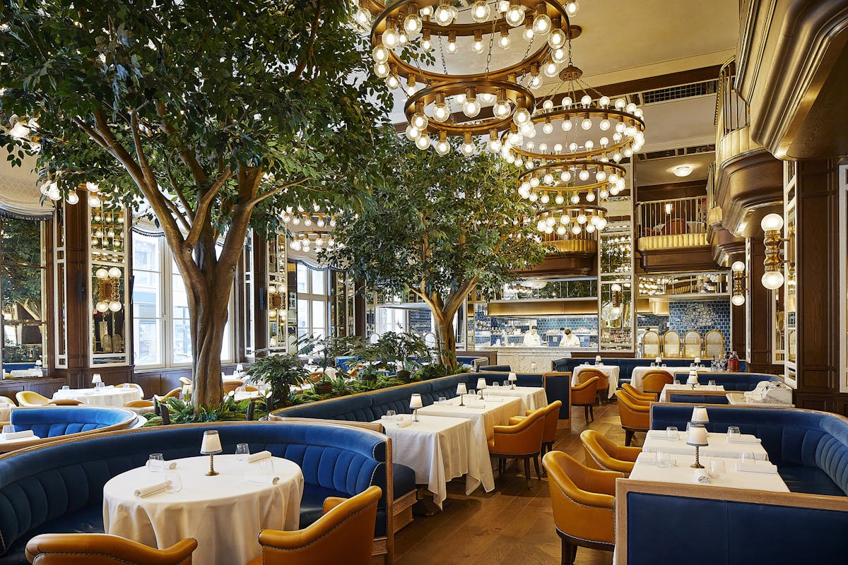 a group of people sitting at a table in front of a building