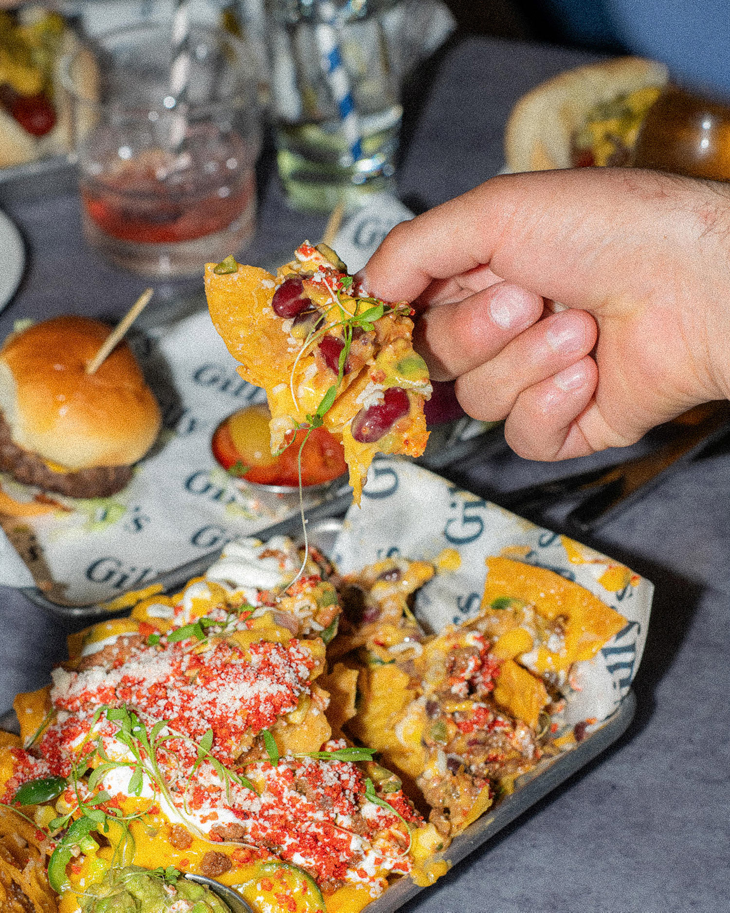 a person holding a piece of pizza