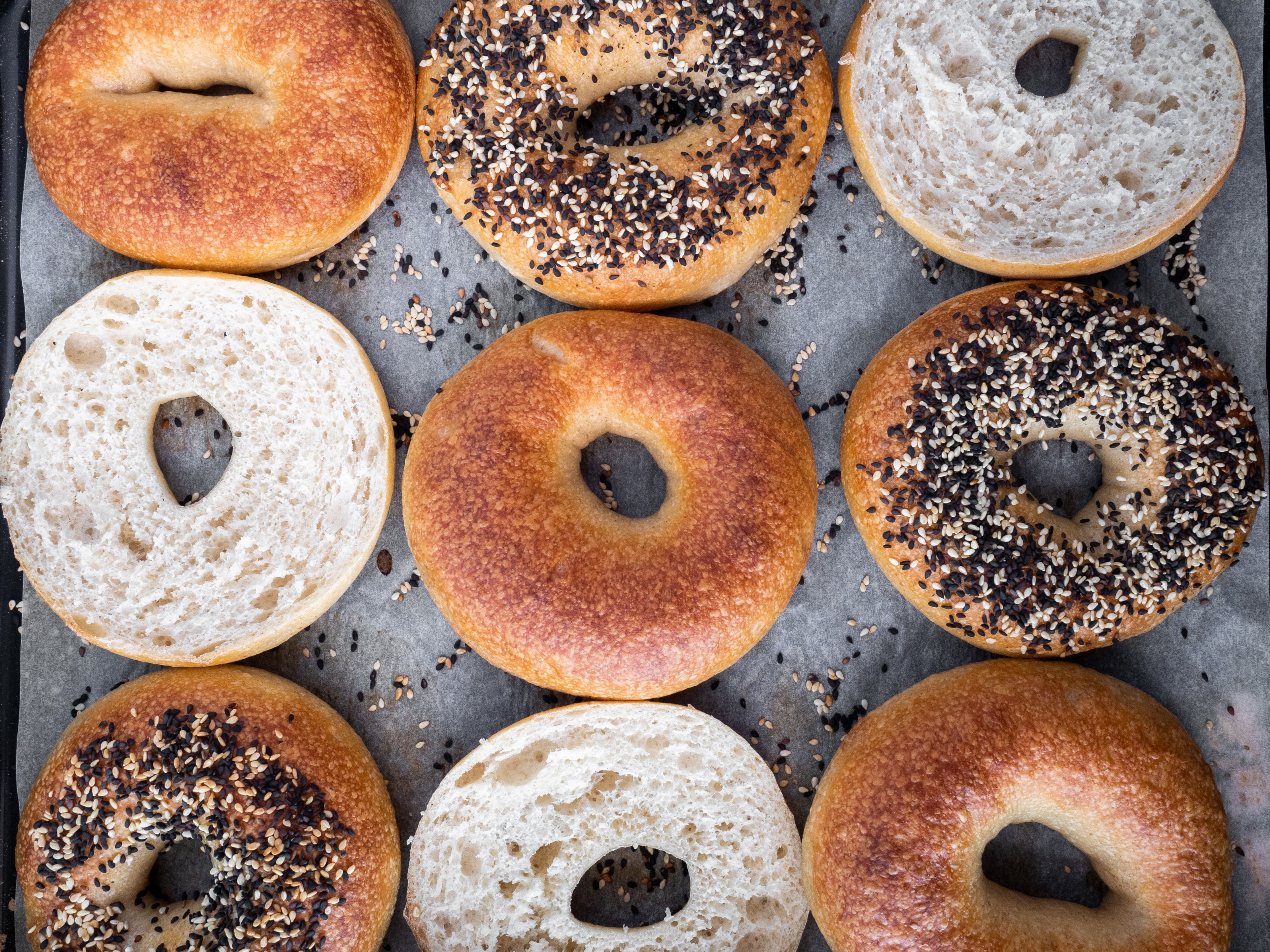 a variety of donuts sitting on a grill