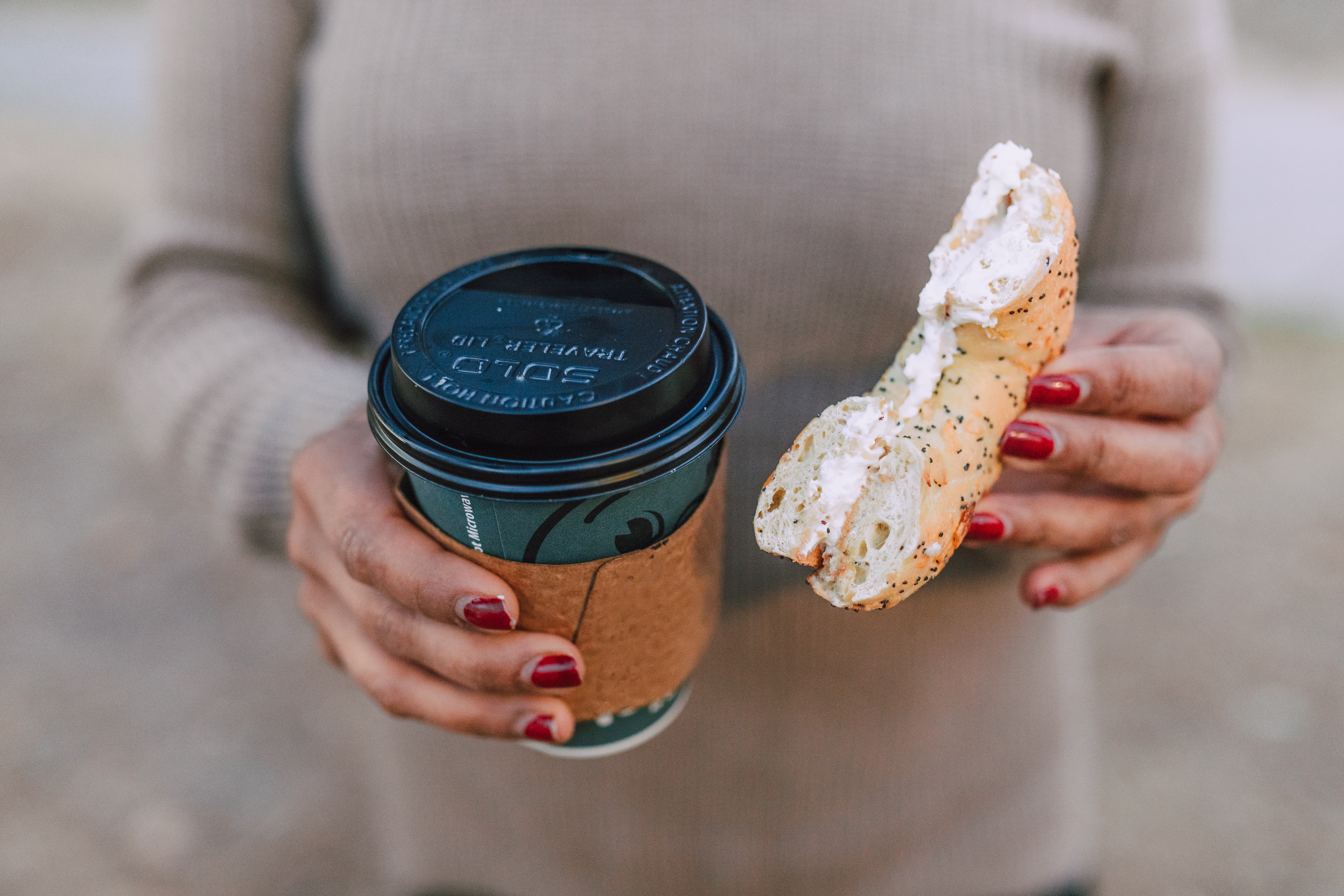 a hand holding a cup of coffee