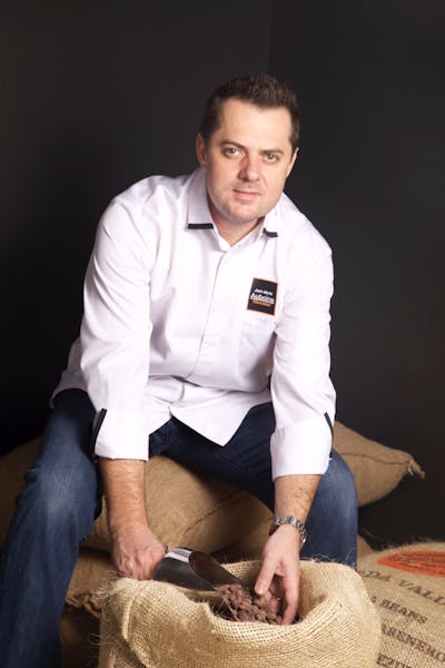 Jean-Marie Auboine sitting on a couch