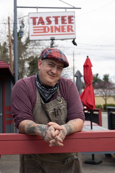 a person sitting on a wooden bench