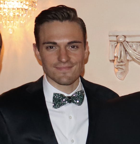 a man standing in front of a mirror posing for the camera