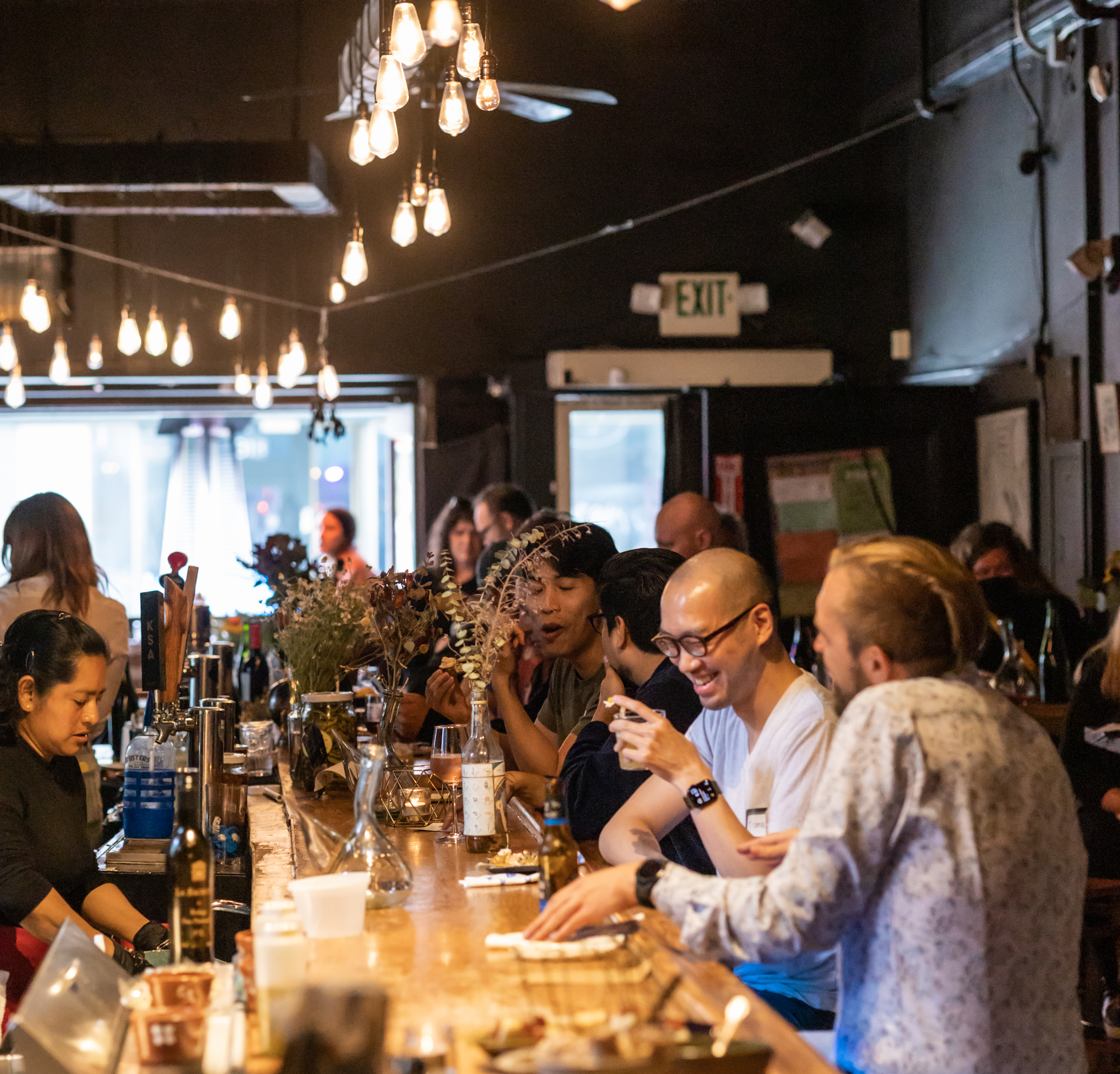 a group of people sitting at a table with wine glasses