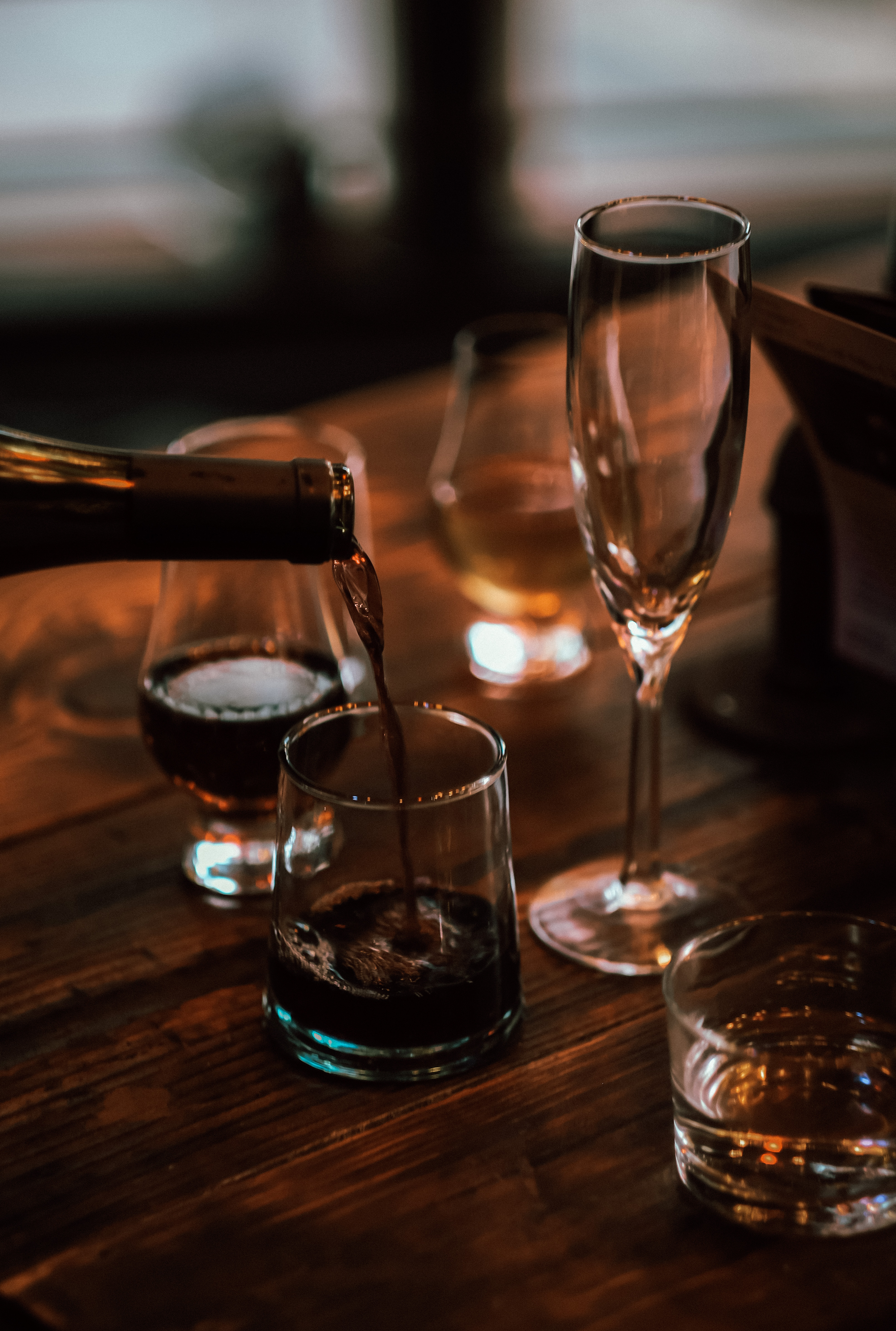 a glass of wine sitting on top of a wooden table