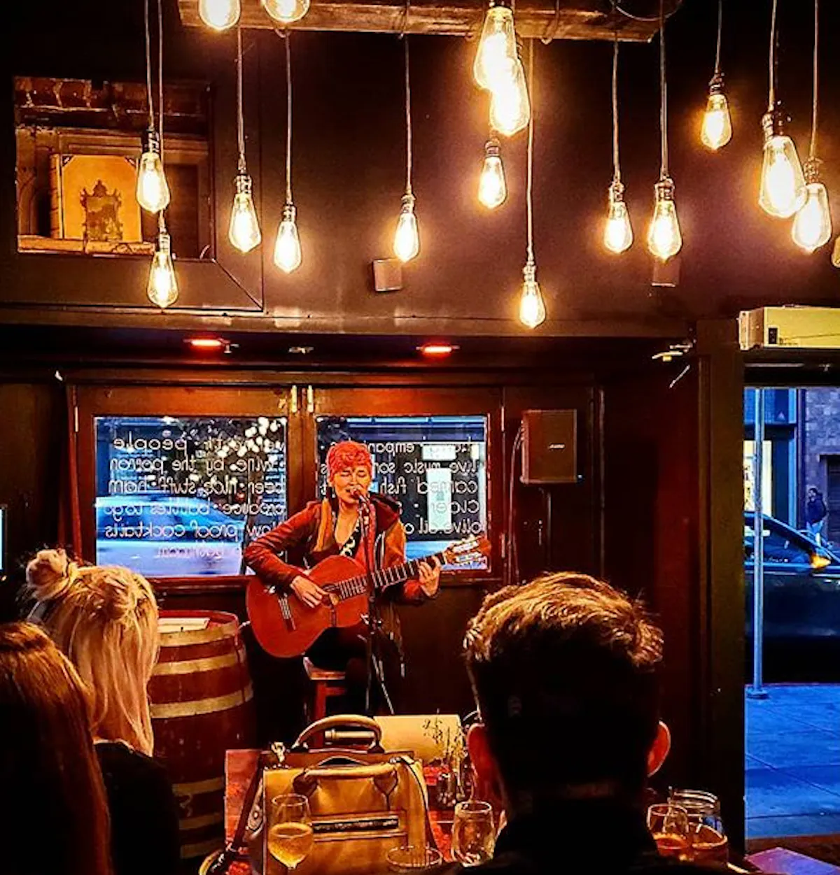 a woman singing and playing guitar