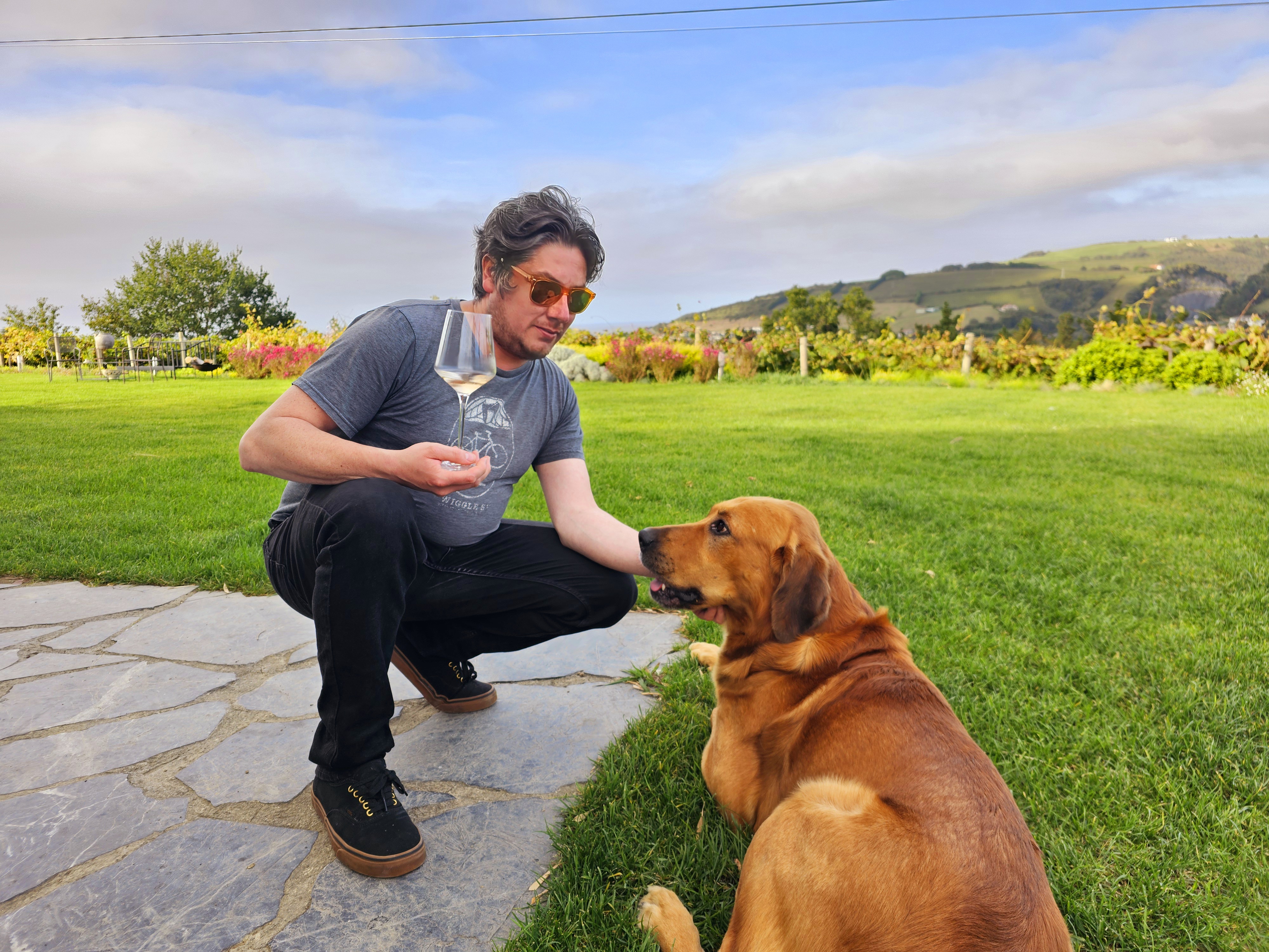 a man and a dog sitting in the grass