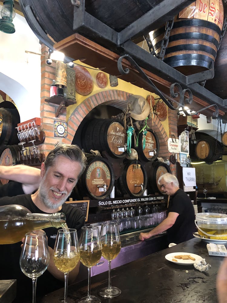 Sérgio Assad standing next to a glass of wine