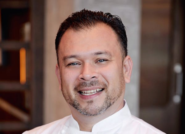 Jorge Chicas wearing a white shirt and smiling at the camera