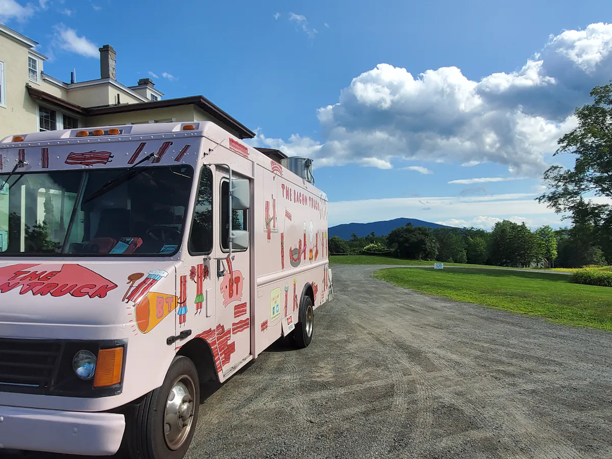a red and white truck parked on the side of a road